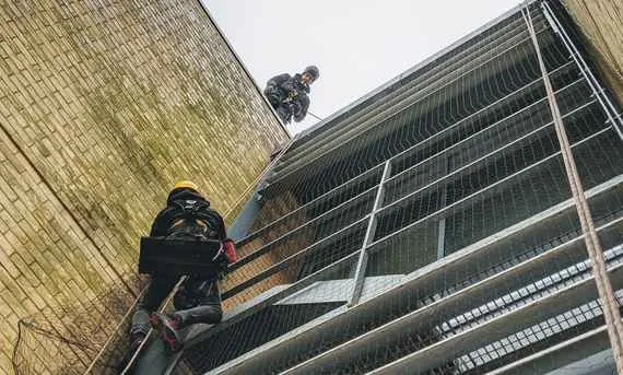 man abseiling down building