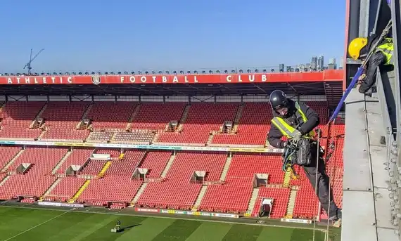 abseiling inside football stadium